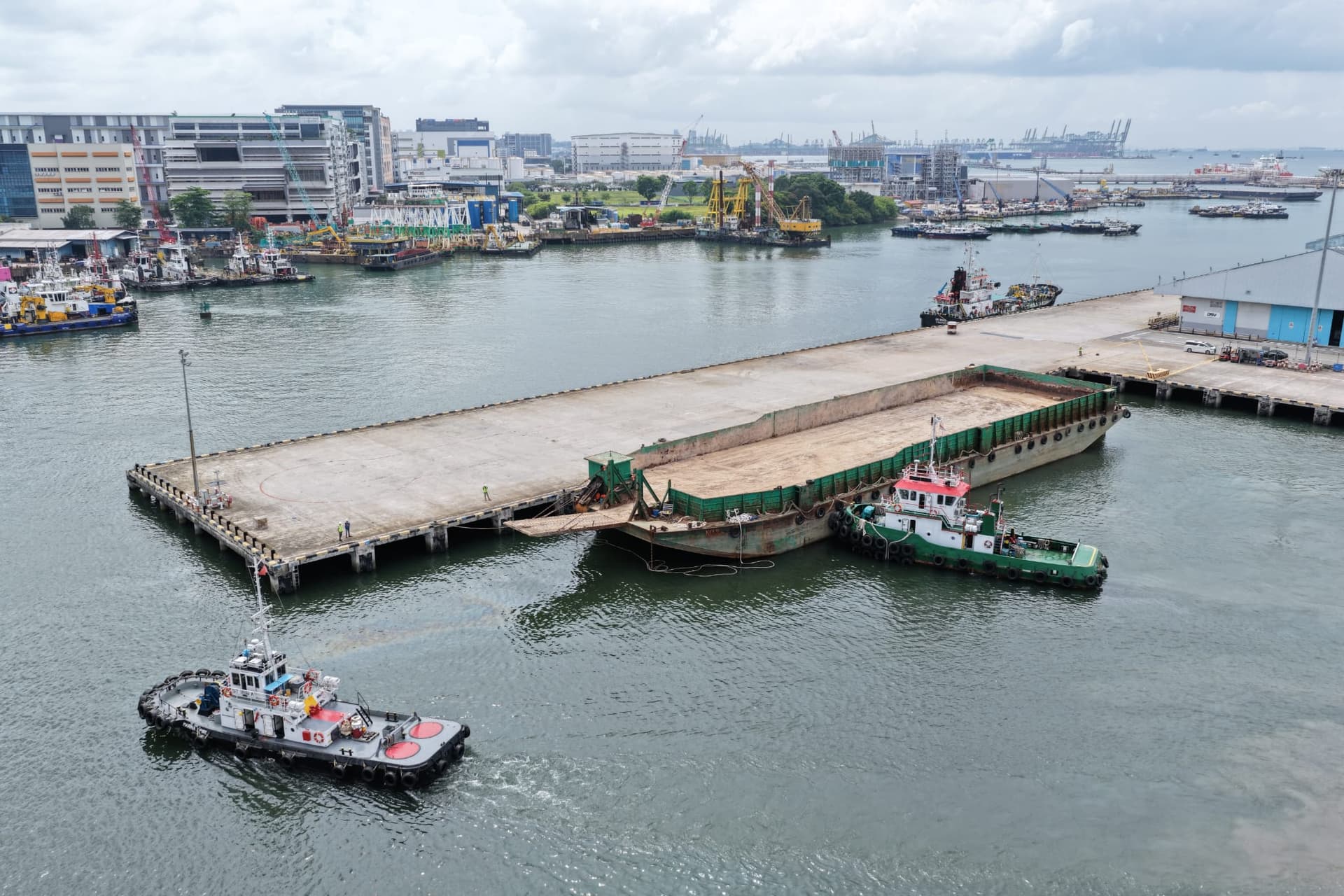 Barge operations with tugboat at Jurong Port Berth J1