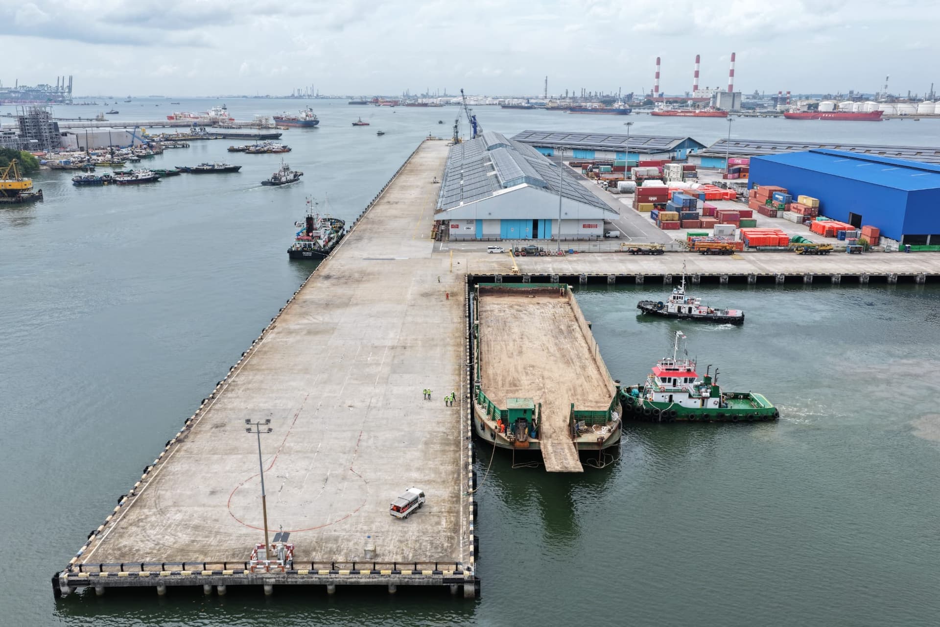 Wide aerial view of barge docking at Jurong Port Berth J1